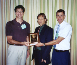 Steve Valles (left), Wayne Hunter (center), and (not shown), Charles Strong, Phat Dang, Roberto Pereira, David Oi, Alexandra Shapiro, and David Williams, receive Annual Achievement Award for Team Research from Rudi Scheffrahn